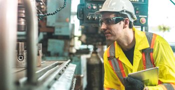 Industrial Engineers in Hard Hats.Work at the Heavy Industry Manufacturing Factory.industrial worker indoors in factory. man working in an industrial factory.Safty first concept.